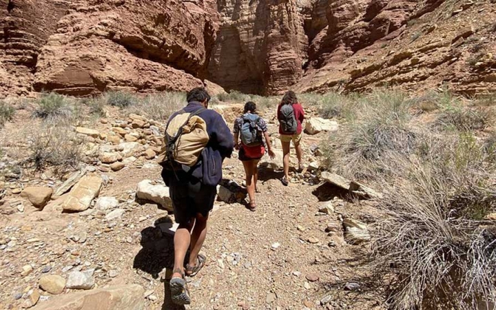 a group of gap year students hike in the southwest on an outward bound course